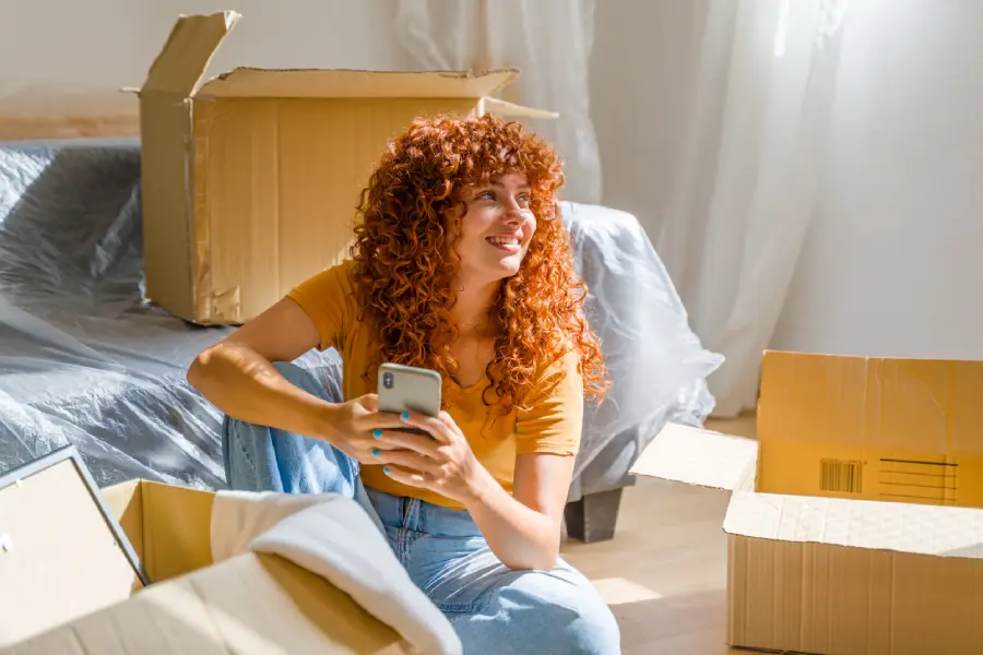 Woman sitting with moving boxes for self-storage in Cookeville